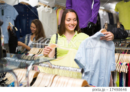 Woman shopping blouse in clothing store. 17498646