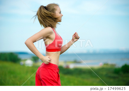 Young woman running summer park rural road. Outdoor exercises. J Young woman running summer park rural road. Outdoor exercises. J 17499625
