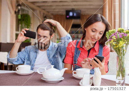 Cheerful young married couple is resting in cafe Cheerful young married couple is resting in cafe 17501327