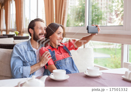 Cheerful young man and woman are making selfie in Cheerful young man and woman are making selfie in 17501332