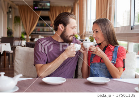 Beautiful young loving couple is dating in cafe Beautiful young loving couple is dating in cafe 17501338