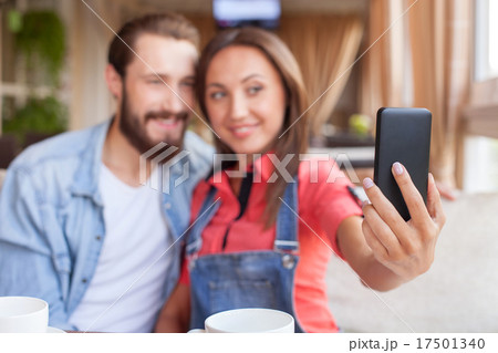 Attractive man and woman are using telephone in 17501340