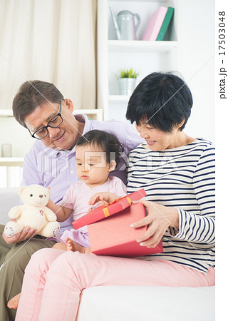 asian grand parents with grand daugther celebrating christmas asian grand parents with grand daugther celebrating christmas 17503048