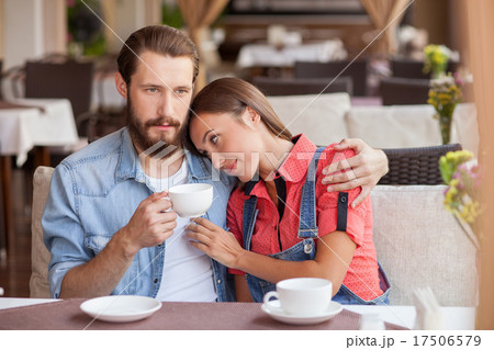 Pretty young loving couple is resting in cafe 17506579