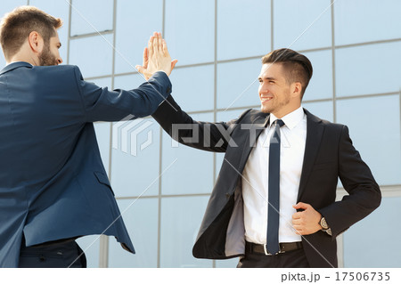 Two  business colleagues high-fiving 17506735