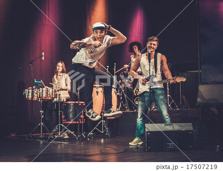 Multiracial music band performing on a stage Multiracial music band performing on a stage 17507219
