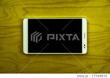 Tablet PC on wooden background 17509630