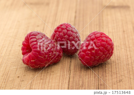 Ripe sweet raspberries on wood table close-up 17513648