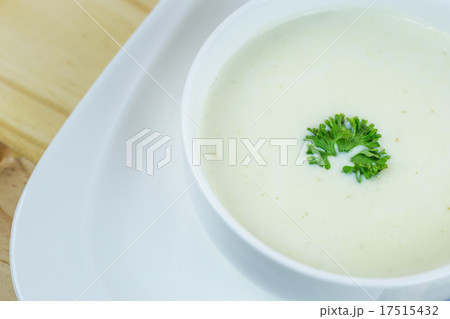 Cream soup in white bowl on wooden table 17515432