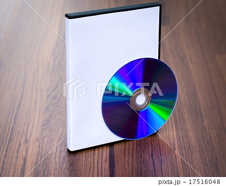 Blank compact disc with cover on wood background ground 17516048