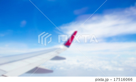 Abstract blur Wing of an airplane flying above the clouds 17516066