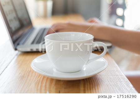 Coffee cup with laptop on old wooden table Coffee cup with laptop on old wooden table 17516290