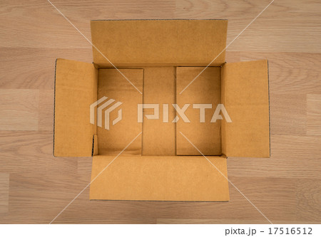 Cardboard box on wood 17516512