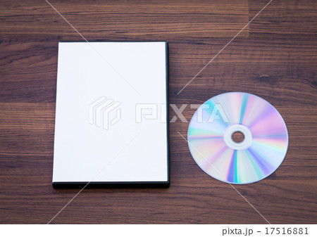 Blank compact disc with cover on wood background ground 17516881