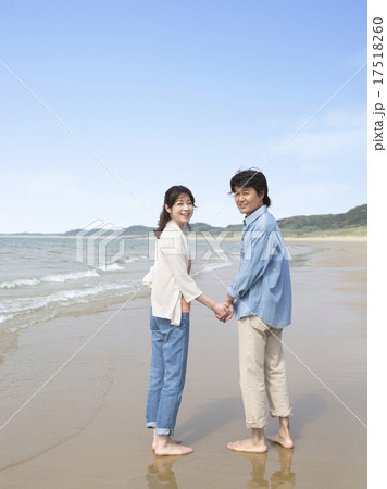 波打ち際で振り向くカップル 波打ち際で振り向くカップル 17518260