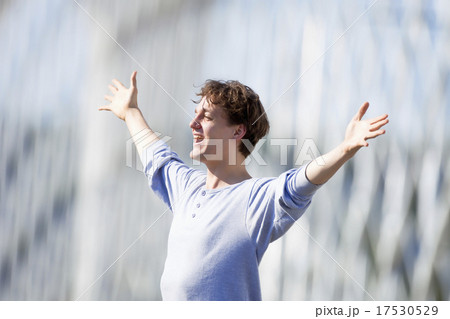 Excited Young Man Stretching out his Arm in Emotion Excited Young Man Stretching out his Arm in Emotion 17530529
