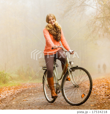 Happy active woman riding bike in autumn park. 17534218