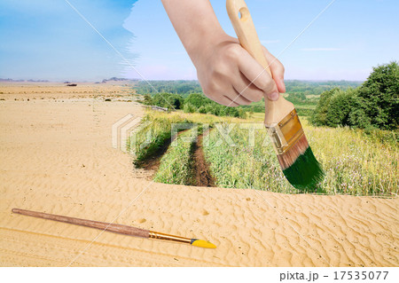 paintbrush paints green countryside in sand desert paintbrush paints green countryside in sand desert 17535077