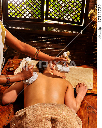 Woman having massage with pouch of rice. 17545729
