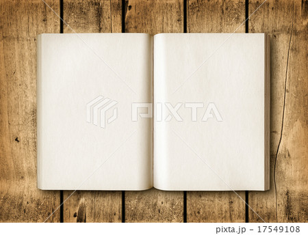Open book on a brown wood table 17549108