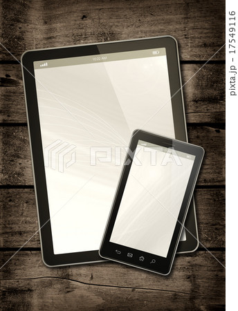 Smartphone and digital tablet PC on a wood table Smartphone and digital tablet PC on a wood table 17549116