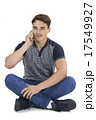 Studio Portrait Of Teenage Boy Talking On Mobile Phone 17549927