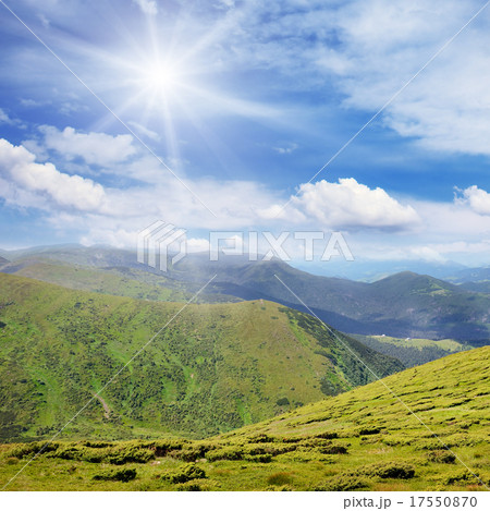 High mountains and sun on blue sky High mountains and sun on blue sky 17550870