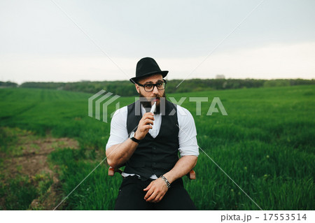 man with a beard smokes electronic cigarette man with a beard smokes electronic cigarette 17553514