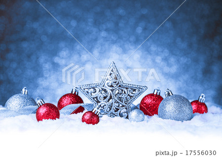 christmas ornament in snow on glitter background 17556030