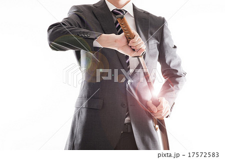 日本刀を持っているビジネスマンの写真素材