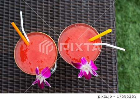 Two cocktails with strawberry and orchid flower 17595265