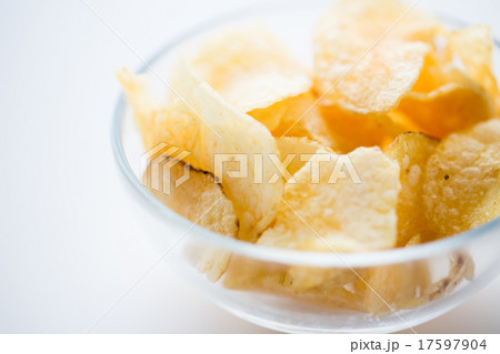 close up of crunchy potato crisps in glass bowl close up of crunchy potato crisps in glass bowl 17597904