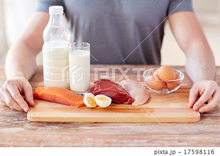 close up of male hands with food rich in protein 17598116