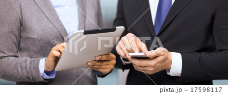 two businesspeople with smartphone and tablet pc 17598117