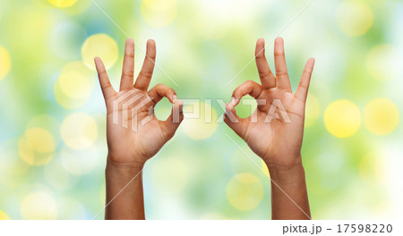 two african hands showing ok sign over blue sky two african hands showing ok sign over blue sky 17598220