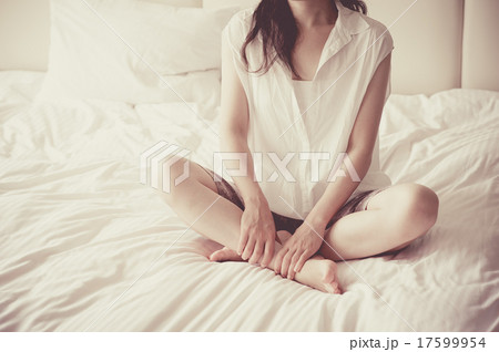 ベッドの上で寂しく座っている女性 ベッドの上で寂しく座っている女性 17599954