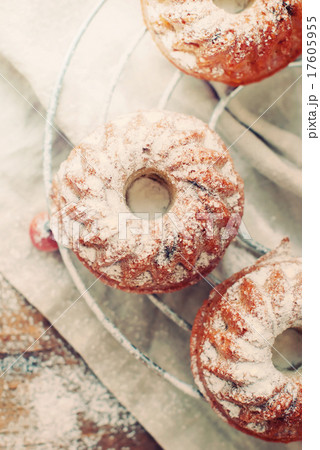 Small Baked Cakes with Icing Sugar. Toned image 17605955