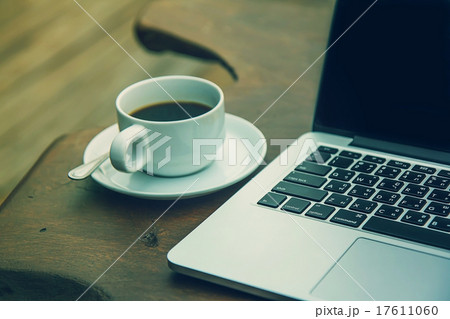 Black coffee in a white cup on a table with a comp 17611060