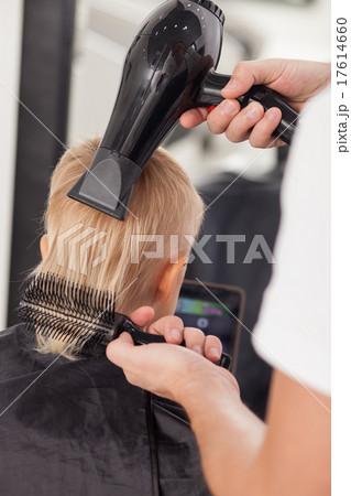 Skilled young barber is working in hairdressing Skilled young barber is working in hairdressing 17614660