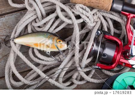 fishing tackles on wooden board with rope fishing tackles on wooden board with rope 17619283