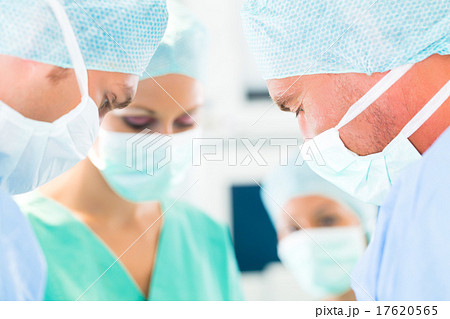 Surgeons operating in operation theater room 17620565
