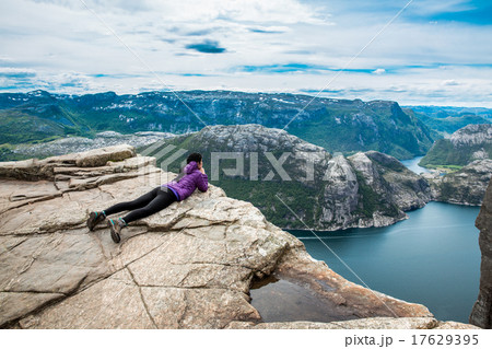 Prekestolen. Woman looking at the landscape from a height. Prekestolen. Woman looking at the landscape from a height. 17629395