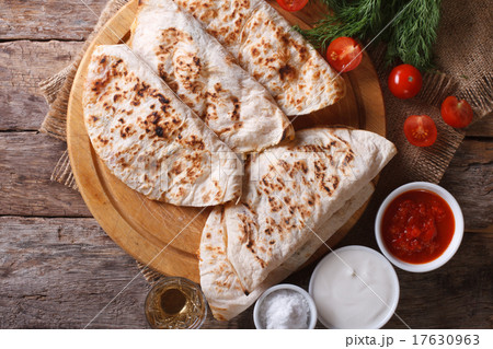 Quesadilla with tomato closeup horizontal top view Quesadilla with tomato closeup horizontal top view 17630963