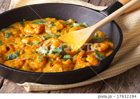 Prawns in curry sauce in a frying pan close-up Prawns in curry sauce in a frying pan close-up 17632194