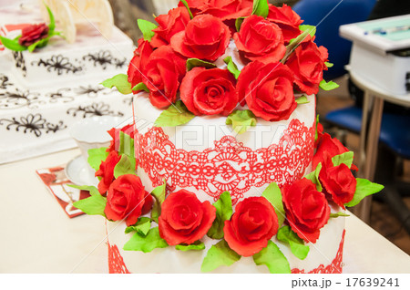 Decorating a wedding cake. Decorating a wedding cake. 17639241