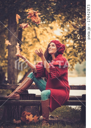 Woman wearing knitted coat in autumn park Woman wearing knitted coat in autumn park 17642873