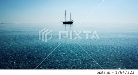 Morning sea with boat on the horizon. Aged photo. 17647222