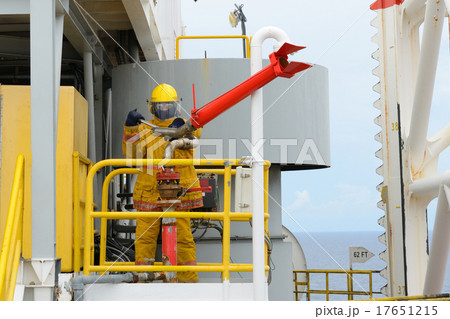 fireman is guarding for offshore helicopter before start up engi 17651215