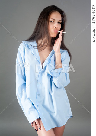 Young pretty brunette woman with cigarette 17654087