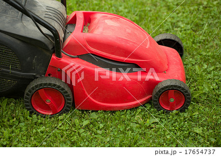red lawnmower on green grass 17654737